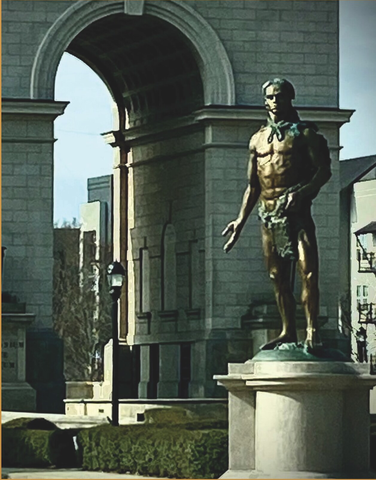Monumental bronze figure outside a stone civic building